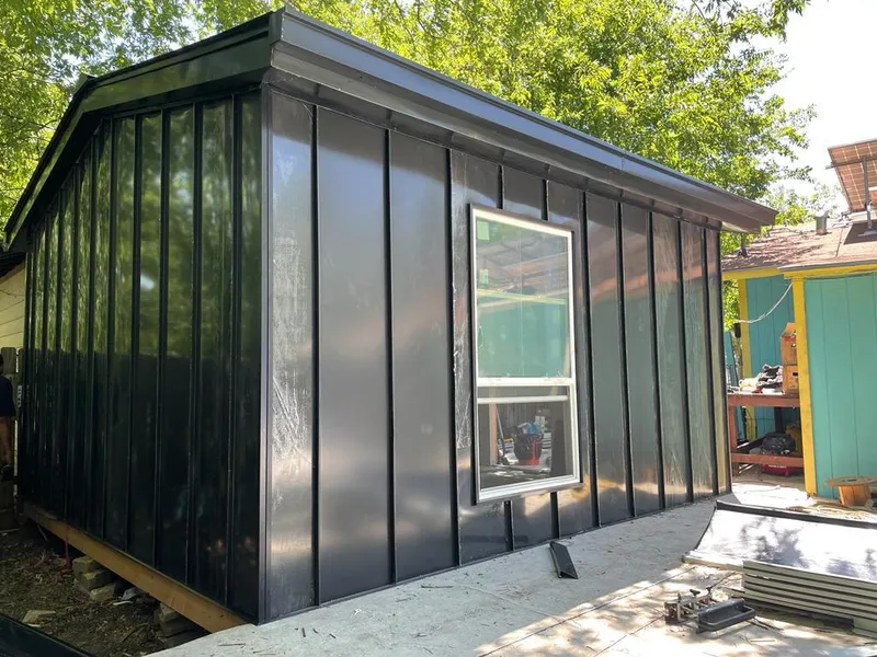 Black standing seam metal wall panels for Roof Inspection in Navasota