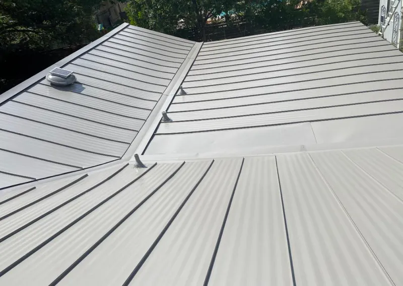 Solar attic fan installed on a metal roof for Roof Ventilation in Navasota
